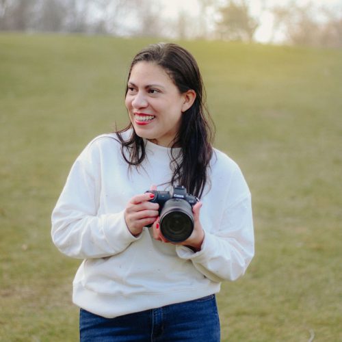 Photo of Merlin Sanchez smiling with her camera