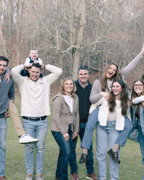 Family smiling during a portraits session in the park