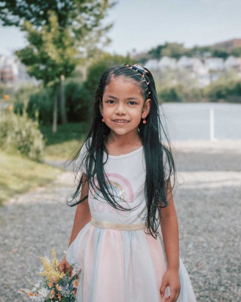 A smiling little girl with water on the background